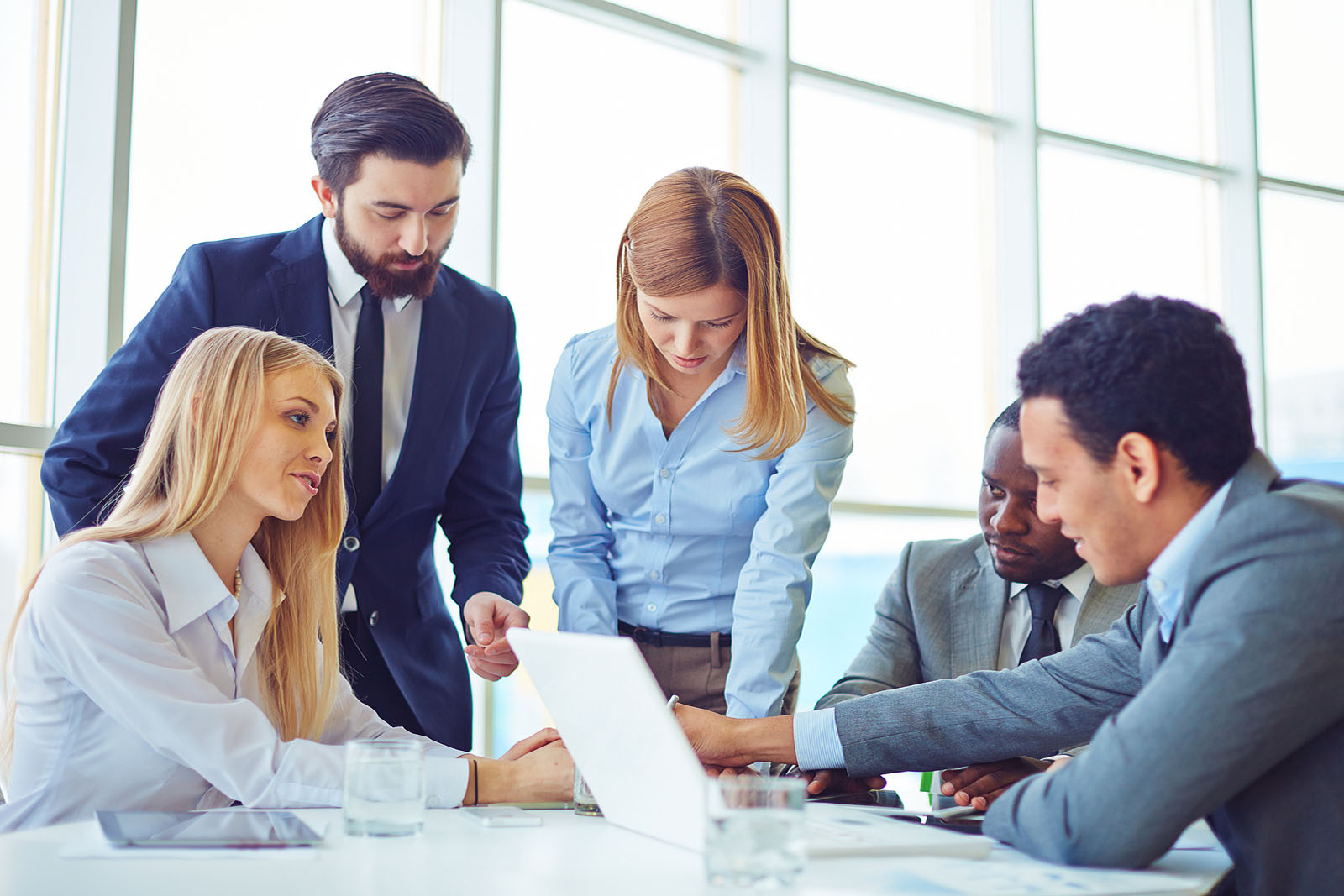 Group of employees discussing ideas and planning work in office Group of employees discussing ideas and planning work in office