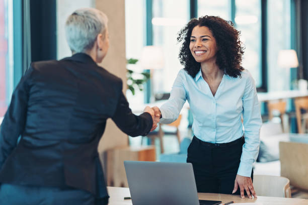 Businesswomen shaking hands in the office Businesswomen shaking hands in the office