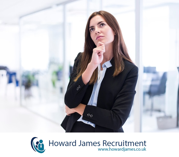 A hiring manager reviewing candidate resumes with a thoughtful expression. A hiring manager reviewing candidate resumes with a thoughtful expression.