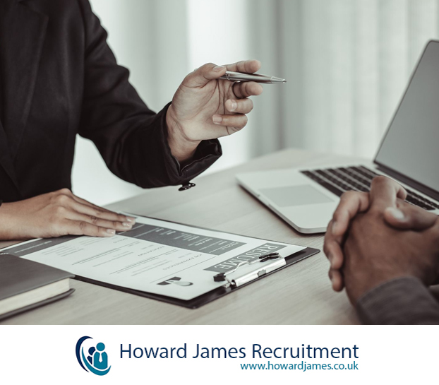 An image of two business professionals reviewing a shortlist of CVs on a tablet in a modern office An image of two business professionals reviewing a shortlist of CVs on a tablet in a modern office