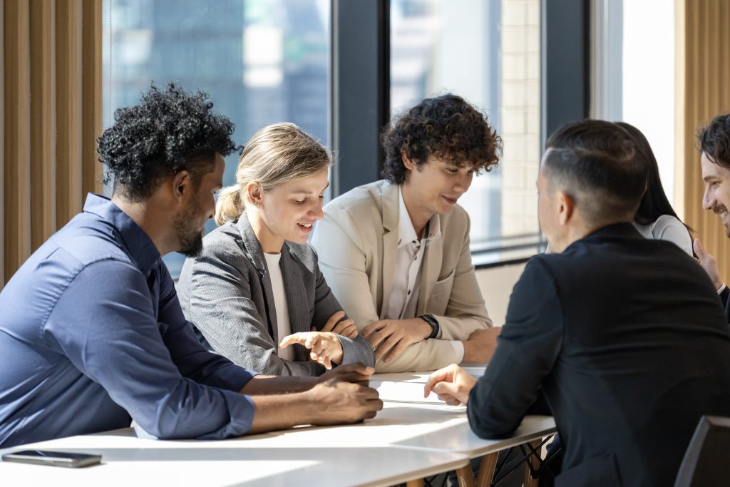 Team of diversity business people are discussing over the new strategic strategy project on investment real estate while working in modern office building for new project and planning