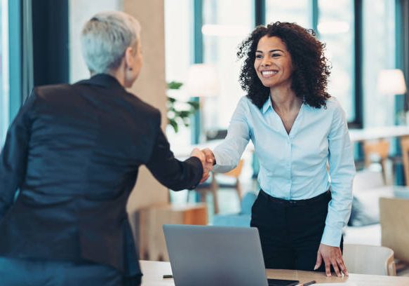 Businesswomen shaking hands in the office Businesswomen shaking hands in the office