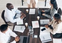 Business meeting, presentation and people above for conference, seminar or workshop in corporate training. Professional black woman, manager or speaker speaking to clients, employees or company staff