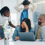 Woman, stress and crisis with team, laptop and stock market trading with support for mistake at office. Person, computer and sad with 404 glitch, error and lost profit with group at investment agency