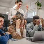 multicultural exhausted worried business workers colleagues work together on laptop in the office try to solve problem