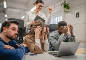 multicultural exhausted worried business workers colleagues work together on laptop in the office try to solve problem