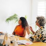 Creative businesswomen having a discussion during a boardroom meeting. Group of multicultural businesswomen brainstorming in an office. Diverse businesswomen working together in an all-female startup.