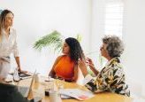 Creative businesswomen having a discussion during a boardroom meeting. Group of multicultural businesswomen brainstorming in an office. Diverse businesswomen working together in an all-female startup.