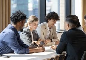 Team of diversity business people are discussing over the new strategic strategy project on investment real estate while working in modern office building for new project and planning